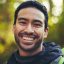 Asian man, portrait or hiking in nature forest, trekking woods or trees environment for adventure, .