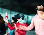Young multiracial friends using futuristic virtual reality glasses - Technology and metaverse concept